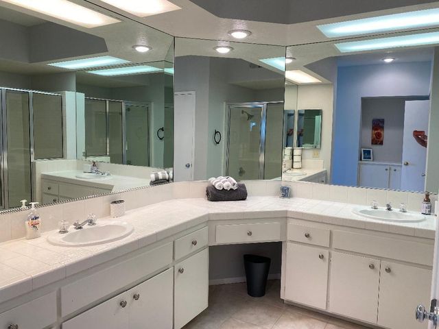 a large bed sitting in a bedroom next to a lamp