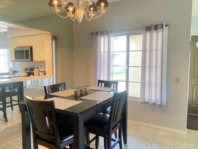 a view of a dining room with furniture and a chandelier
