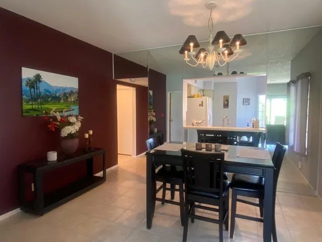 a kitchen with granite countertop a sink dishwasher stove and microwave with wooden floor