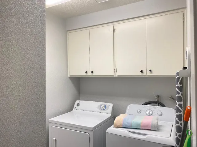 a bedroom with a large bed and a flat tv screen on a dresser