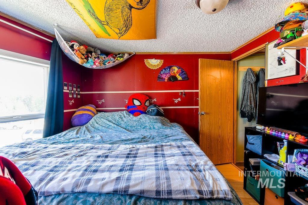 609 North Almon Street, Unit 3022 Moscow, ID 83843 - Photo 22 of 26 Bedroom with a textured ceiling and wood finished floors