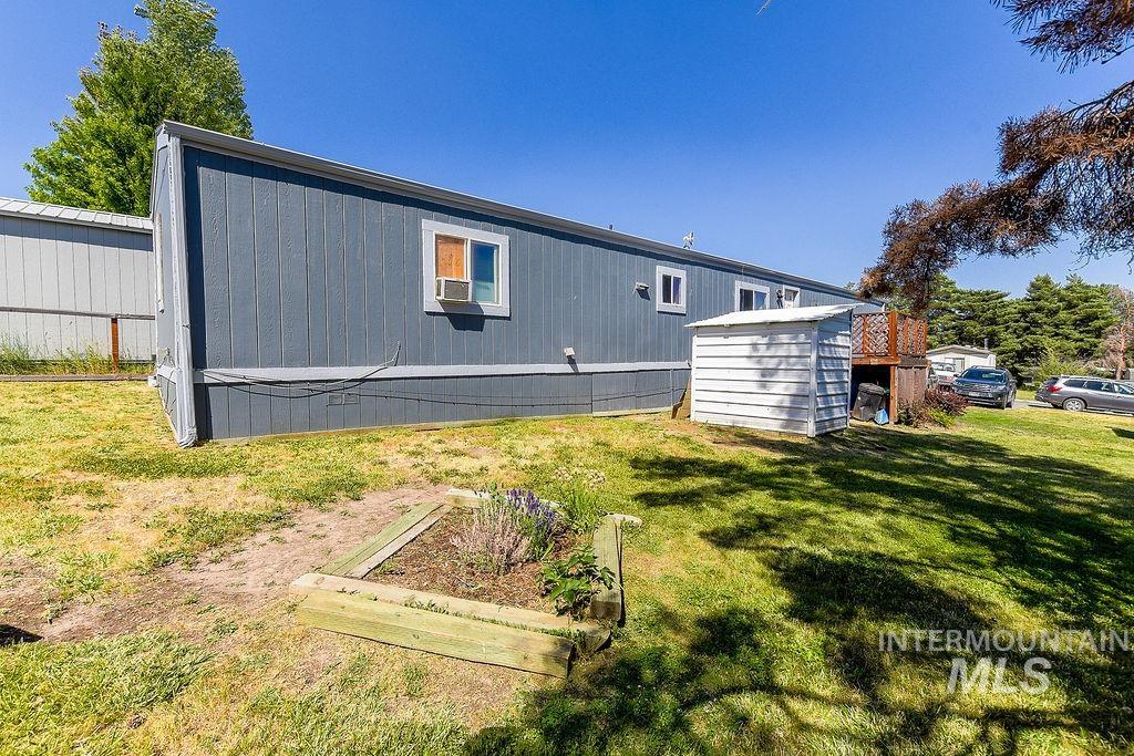 609 North Almon Street, Unit 3022 Moscow, ID 83843 - Photo 26 of 26 Back of property featuring a lawn and a vegetable garden