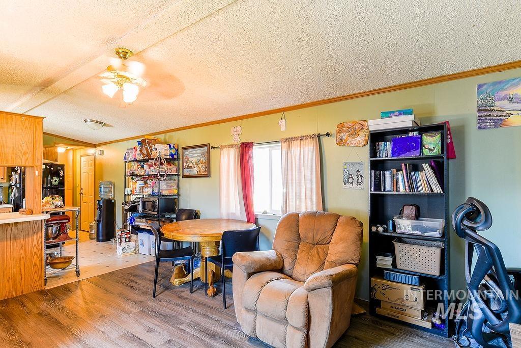 609 North Almon Street, Unit 3022 Moscow, ID 83843 - Photo 5 of 26 Dining area with ornamental molding, wood finished floors, a ceiling fan, and a textured ceiling
