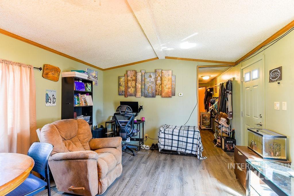 609 North Almon Street, Unit 3022 Moscow, ID 83843 - Photo 7 of 26 Living room featuring crown molding, wood finished floors, and a textured ceiling