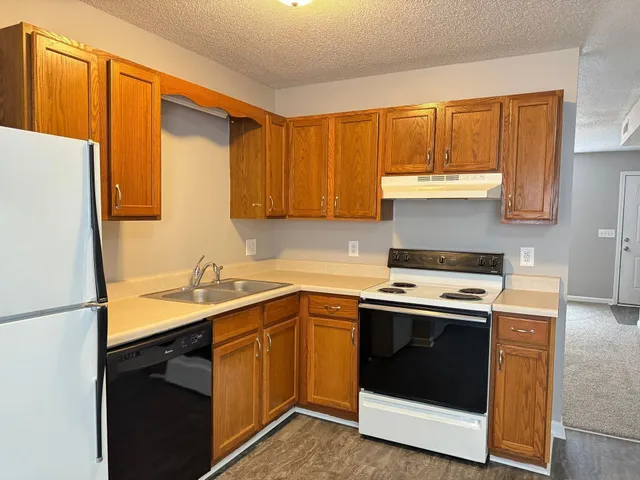 a kitchen with a sink stove and refrigerator