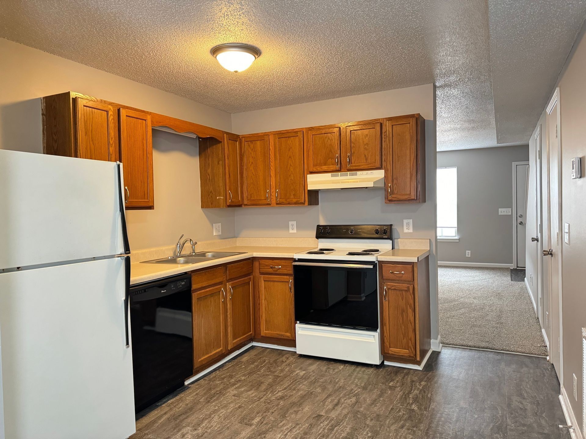 2453 Wilson Road, Unit 4 Clarksville, TN 37043 - Photo 7 of 20 a kitchen with stainless steel appliances granite countertop a refrigerator a stove a sink and a microwave