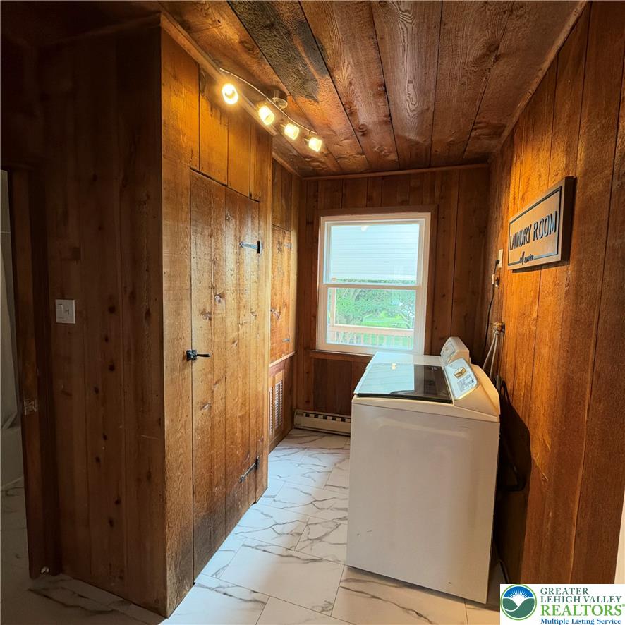 5111 Vera Cruz Road Emmaus, PA 18049 - Photo 24 of 44 Rich wood paneling walls and ceilings pair beautifully with marble-patterned tile flooring.