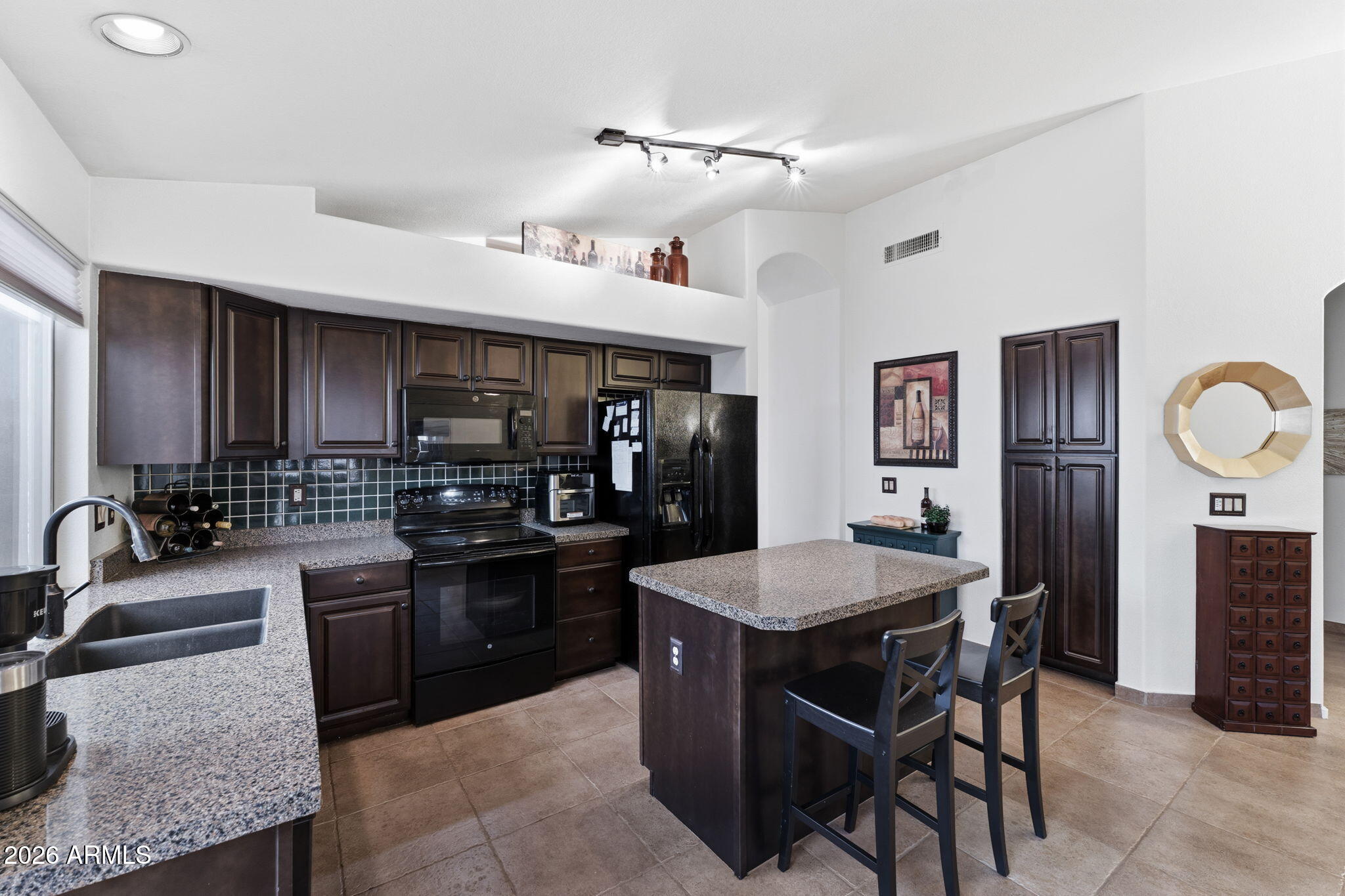 6526 East Raftriver Street Mesa, AZ 85215 - Photo 3 of 17 a kitchen with granite countertop a sink stainless steel appliances and cabinets