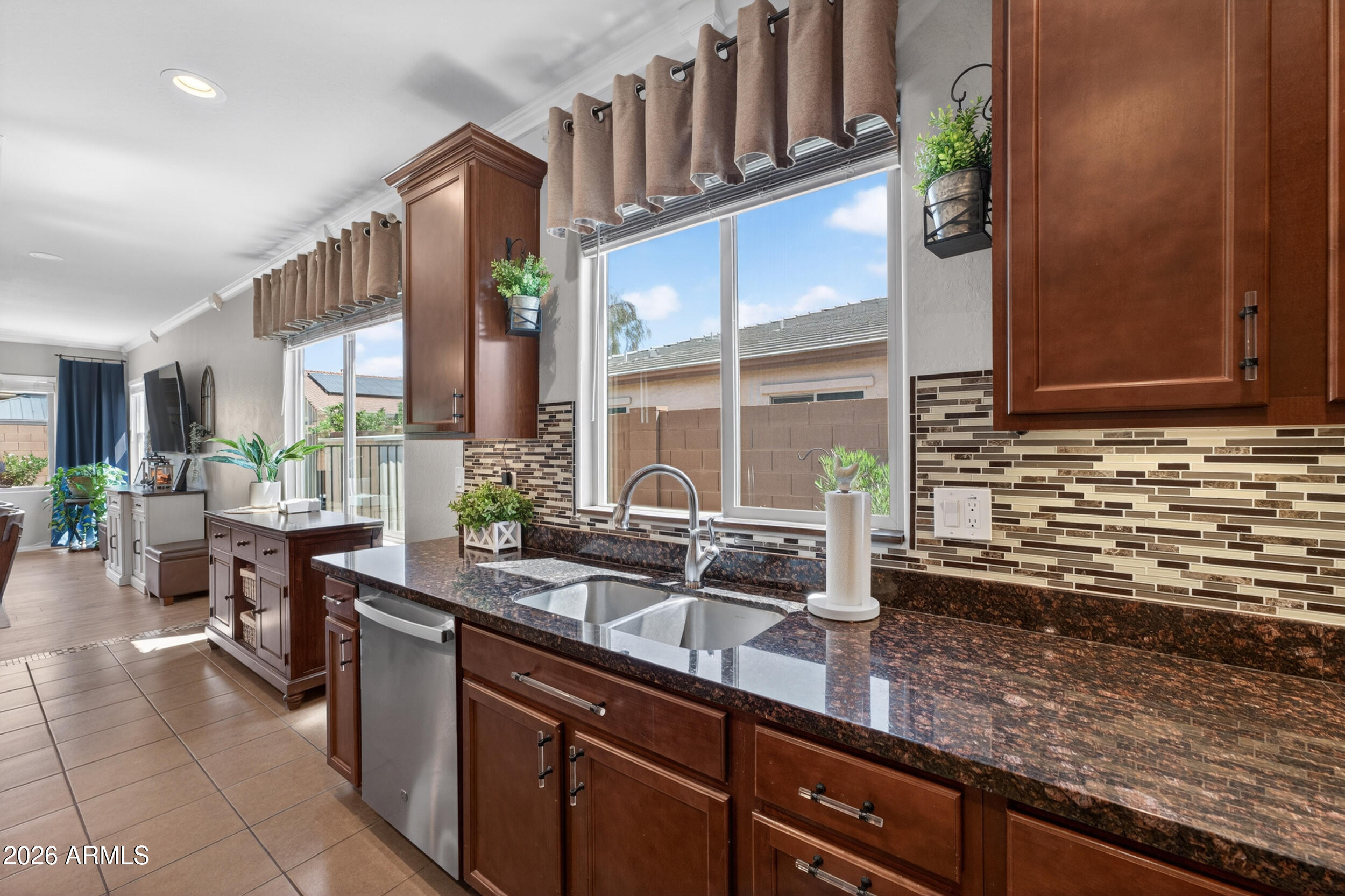 18612 West Mountain View Road Waddell, AZ 85355 - Photo 11 of 71 a kitchen with sink a counter and cabinets