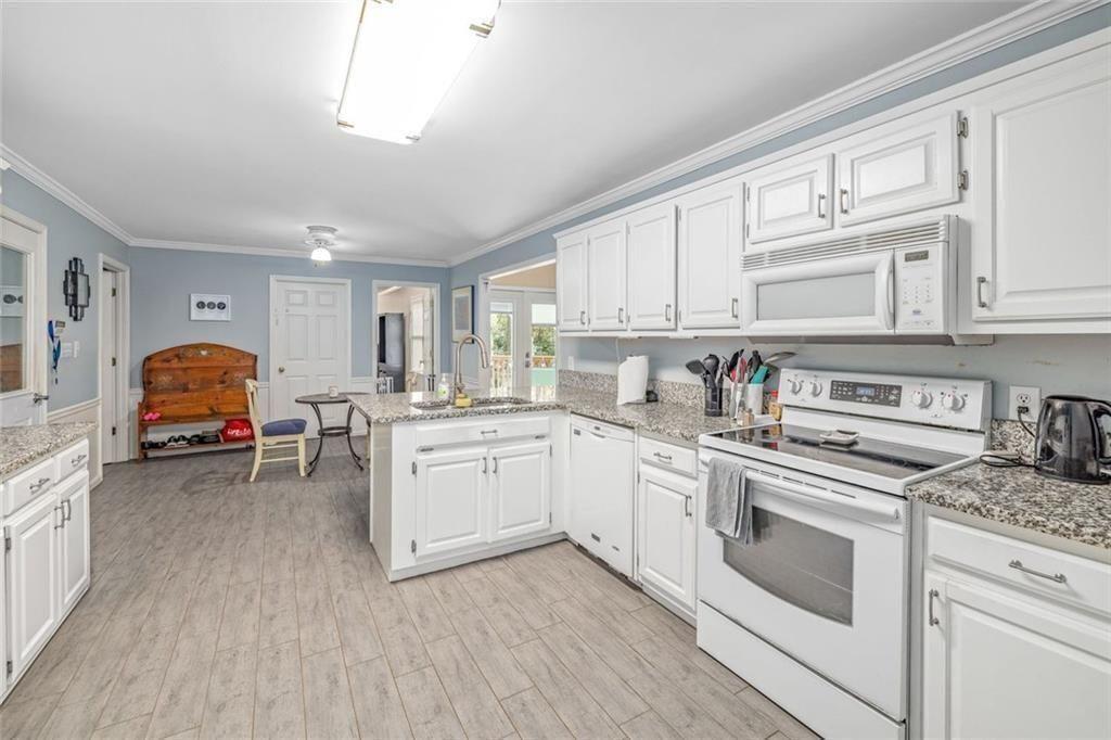 4609 Hunters Court Gainesville, GA 30507 - Photo 12 of 46 a kitchen with granite countertop a sink appliances cabinets and counter space