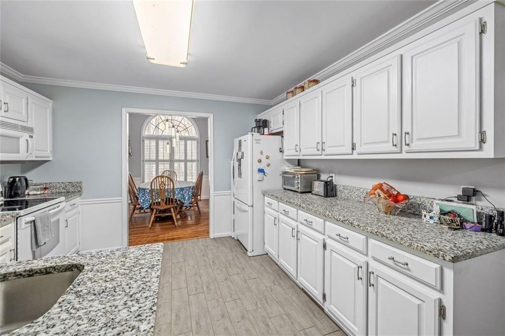4609 Hunters Court Gainesville, GA 30507 - Photo 13 of 46 a kitchen with white cabinets and sink