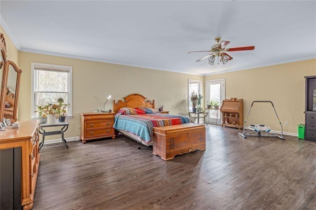 4609 Hunters Court Gainesville, GA 30507 - Photo 16 of 46 a bedroom with furniture and a wooden floor