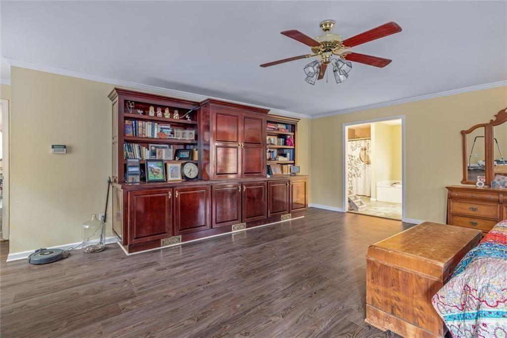 4609 Hunters Court Gainesville, GA 30507 - Photo 17 of 46 a living room with furniture a bookshelf and wooden floor