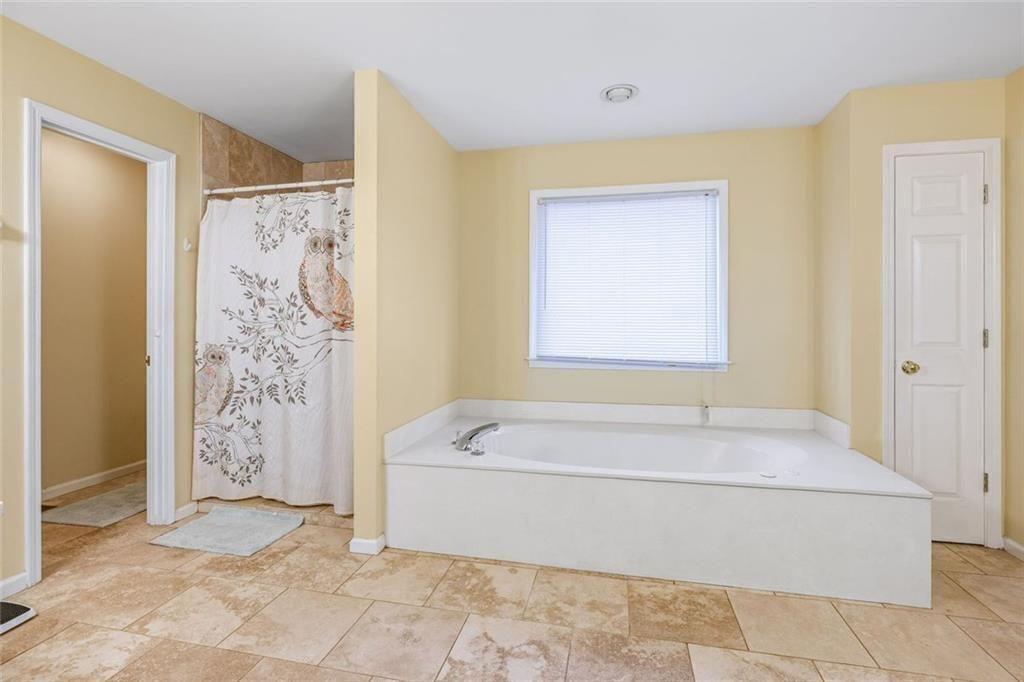 4609 Hunters Court Gainesville, GA 30507 - Photo 18 of 46 a bathroom with a bathtub and shower