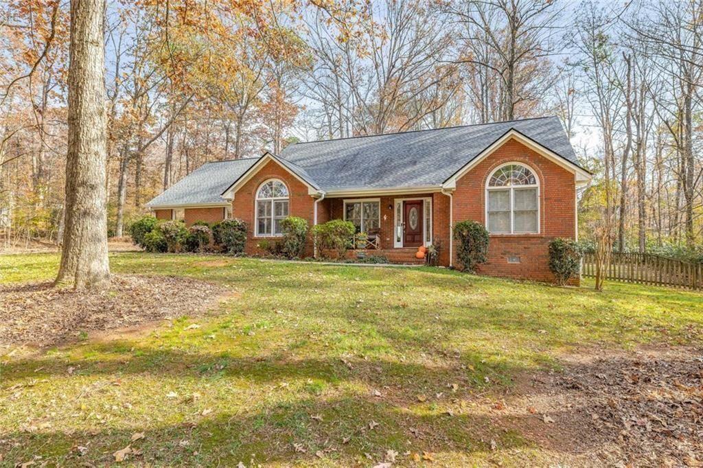 4609 Hunters Court Gainesville, GA 30507 - Photo 2 of 46 a front view of a house with a yard and trees