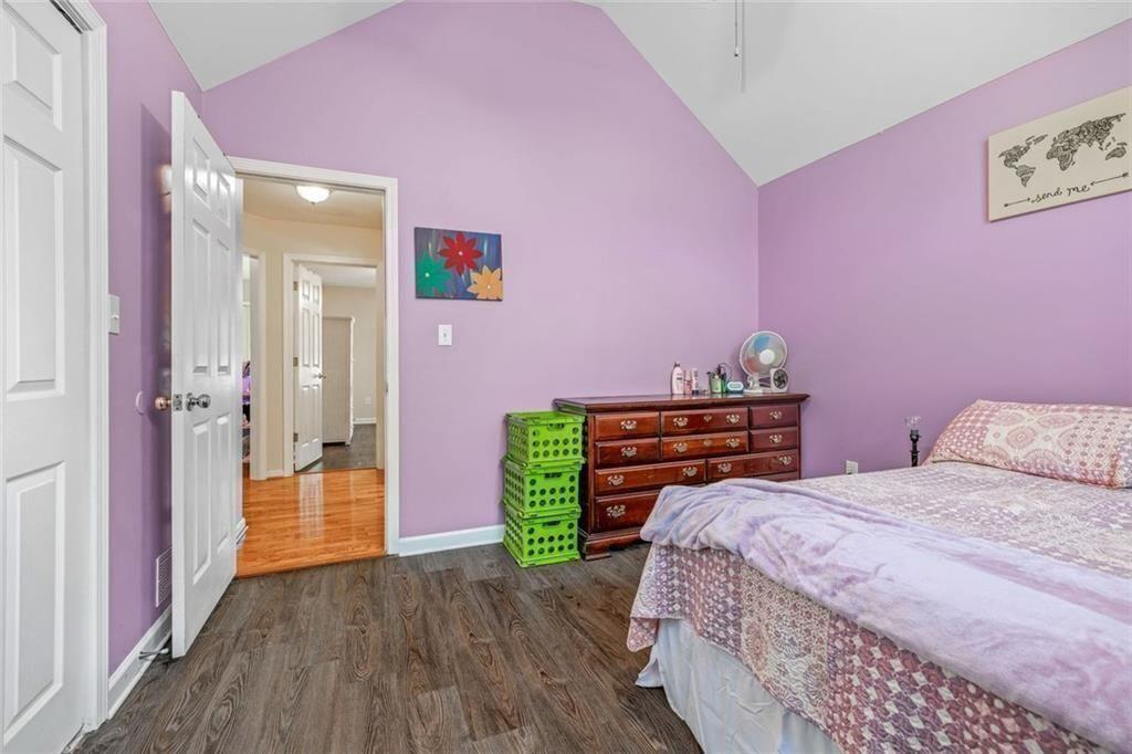 4609 Hunters Court Gainesville, GA 30507 - Photo 25 of 46 a bedroom with a bed and a wooden floor
