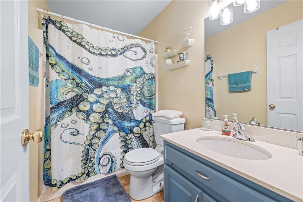 4609 Hunters Court Gainesville, GA 30507 - Photo 26 of 46 a bathroom with a toilet sink and mirror