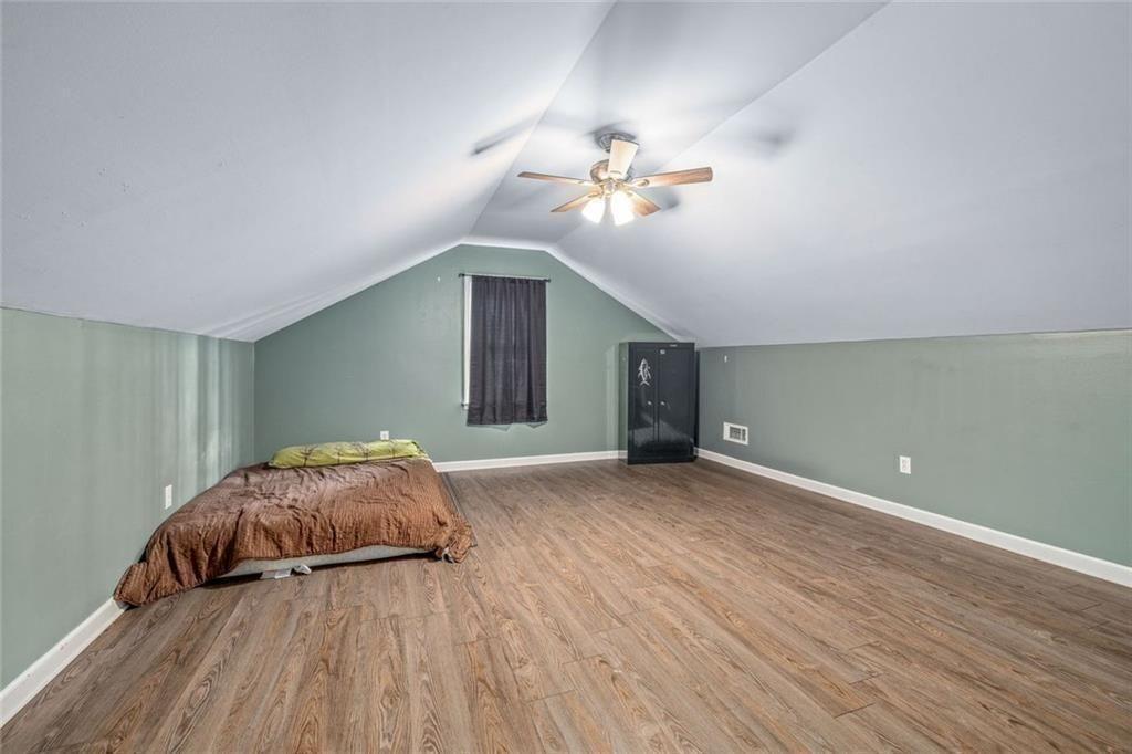 4609 Hunters Court Gainesville, GA 30507 - Photo 28 of 46 a bedroom with a bed and a chandelier