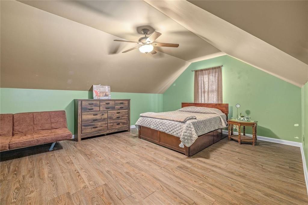 4609 Hunters Court Gainesville, GA 30507 - Photo 30 of 46 a bedroom with a bed and ceiling fan