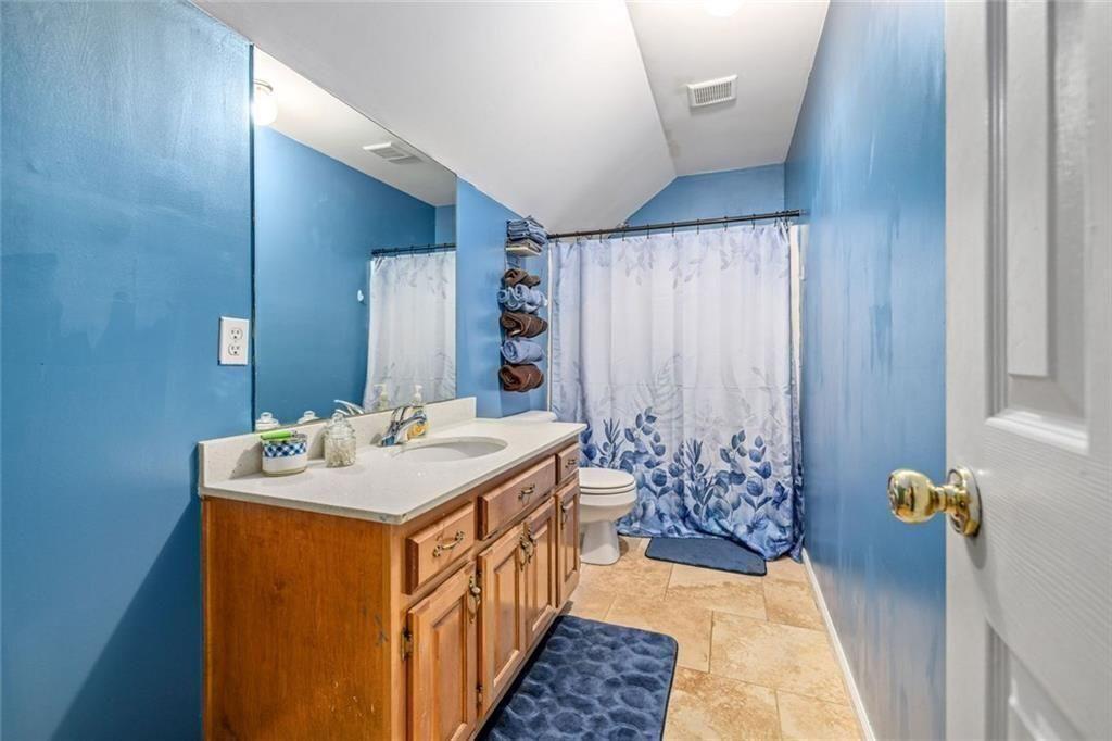 4609 Hunters Court Gainesville, GA 30507 - Photo 32 of 46 a bathroom with a sink a toilet and shower
