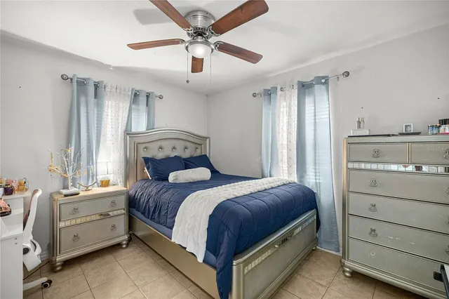 a bedroom with a bed and ceiling fan