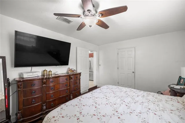 a bedroom with a bed and a flat screen tv