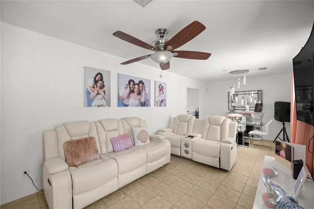 a living room with furniture and a ceiling fan