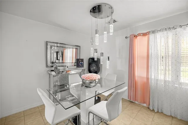 a dining room with furniture and chandelier