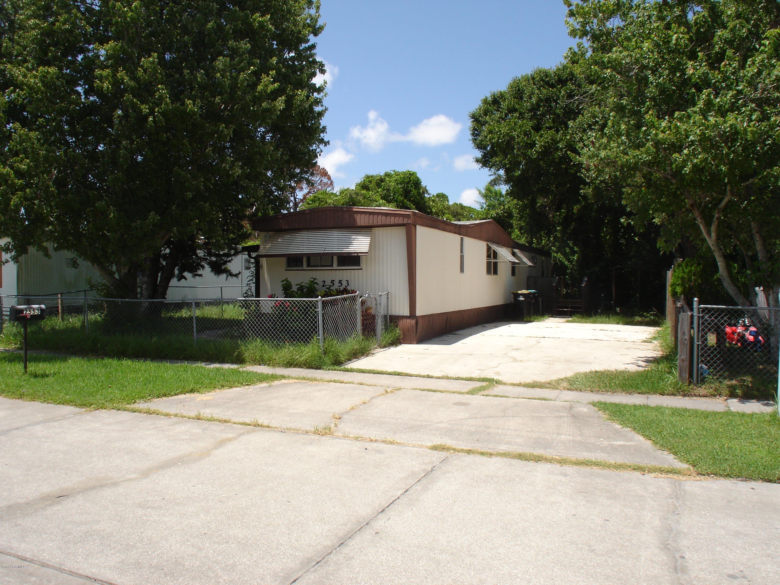 2553 Amberly Road Northeast Palm Bay, FL 32905 - Photo 1 of 26 FRONT WITH CONCRETE DRIVEWAY
