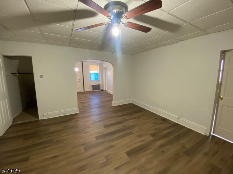 310 Centre Street Elizabeth, NJ 07202 - Photo 2 of 3 wooden floor in an empty room with a window