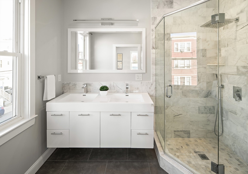 9-11 Boynton Street, Unit 2 Boston, MA 02130 - Photo 13 of 30 a spacious bathroom with a shower sink and mirror