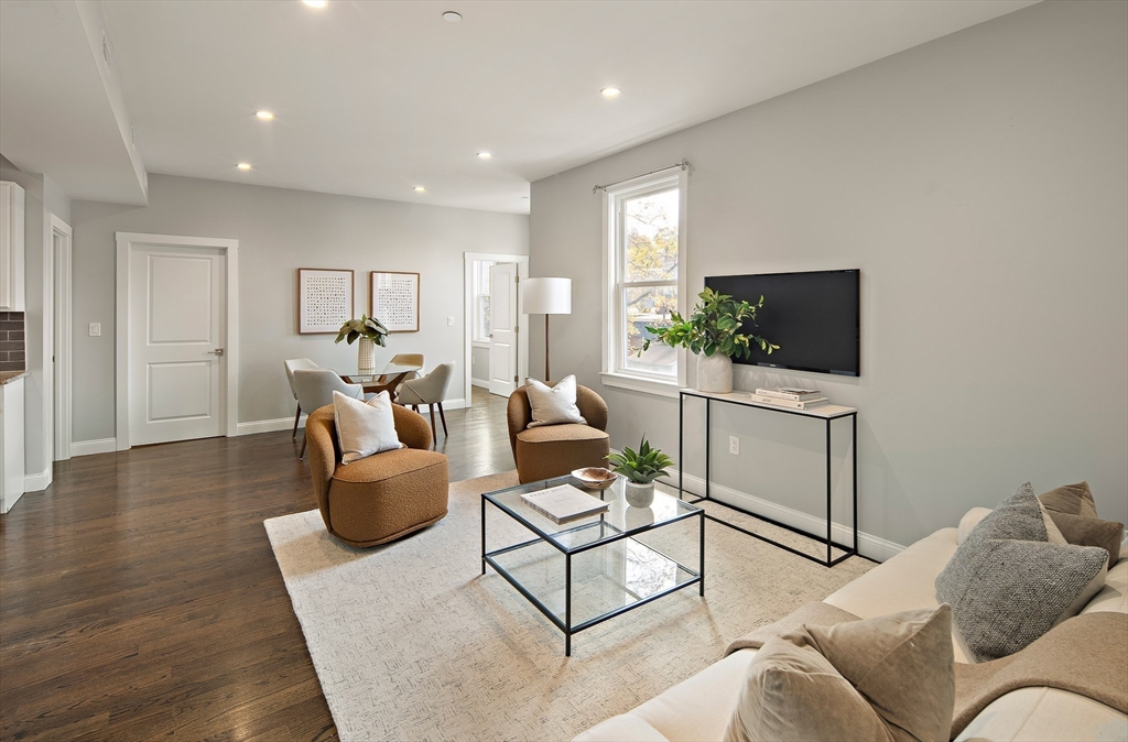 9-11 Boynton Street, Unit 2 Boston, MA 02130 - Photo 2 of 30 a living room with furniture and a flat screen tv