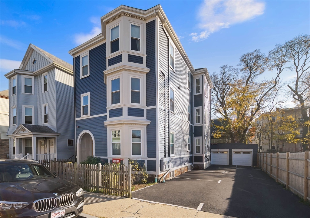 9-11 Boynton Street, Unit 2 Boston, MA 02130 - Photo 27 of 30 a front view of a residential apartment building with a yard