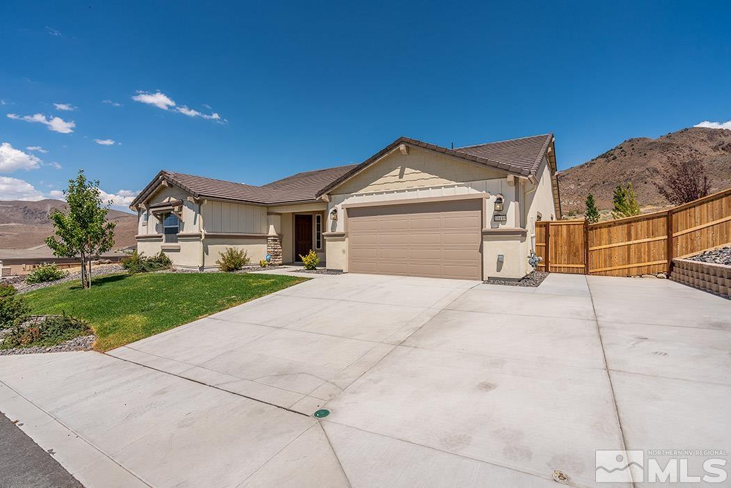10410 Palladium Mine Drive Reno, NV 89521 - Photo 1 of 26 a front view of a house with a yard and garage