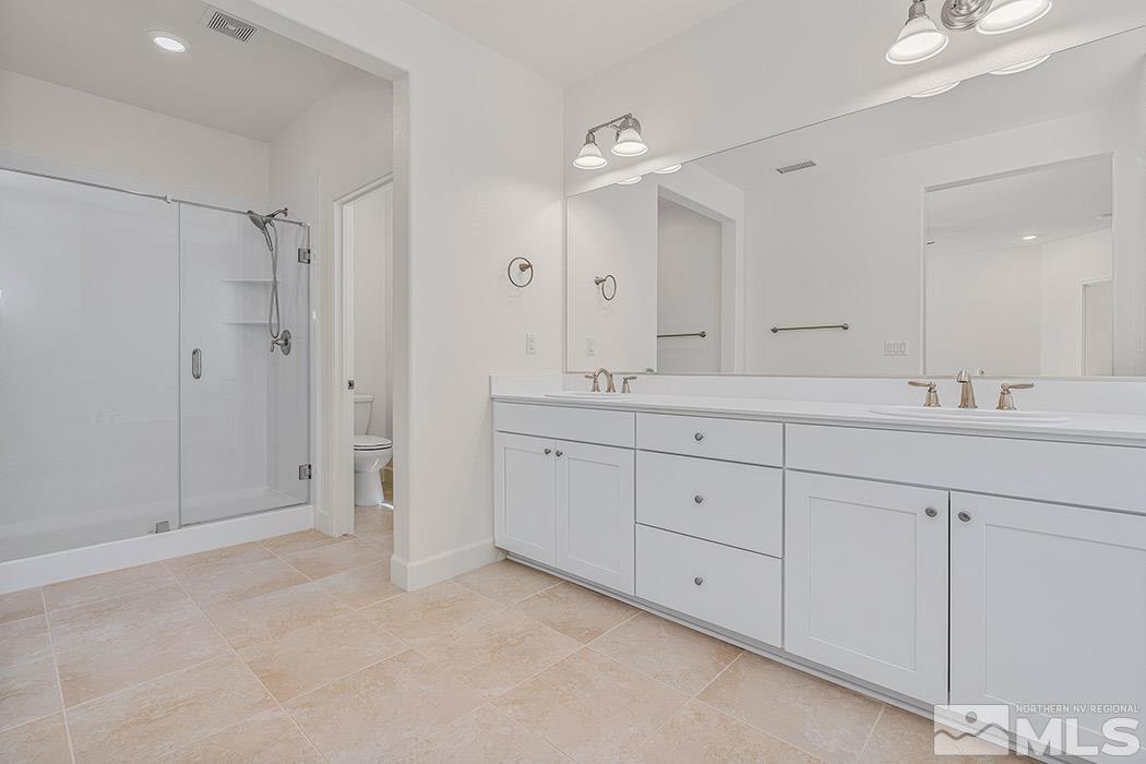 10410 Palladium Mine Drive Reno, NV 89521 - Photo 19 of 26 a spacious bathroom with 2 sink shower and a mirror