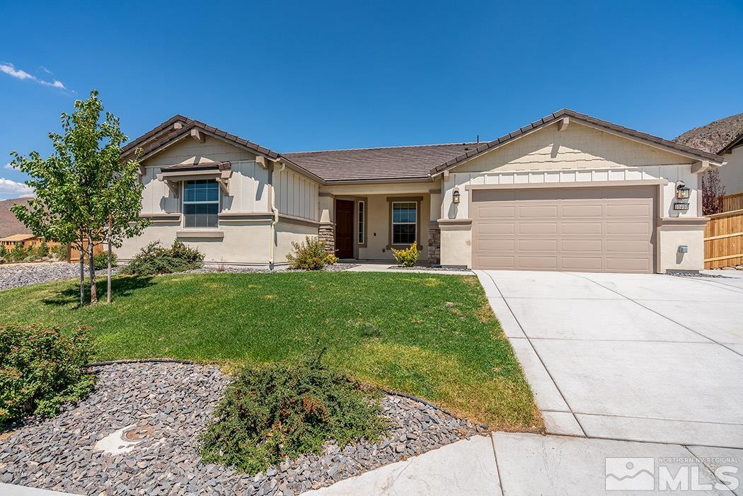 10410 Palladium Mine Drive Reno, NV 89521 - Photo 2 of 26 a front view of a house with a yard and garage