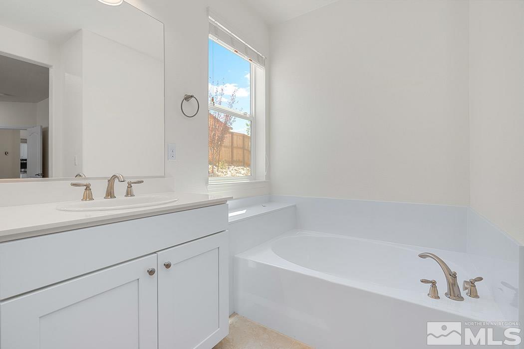 10410 Palladium Mine Drive Reno, NV 89521 - Photo 24 of 26 a bathroom with a bathtub sink and mirror