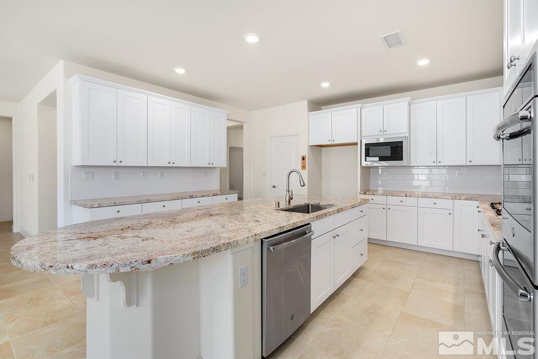 10410 Palladium Mine Drive Reno, NV 89521 - Photo 8 of 26 a kitchen with a sink stove cabinets and refrigerator