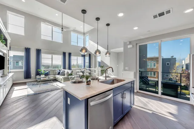 a open kitchen with stainless steel appliances granite countertop a sink stove and refrigerator