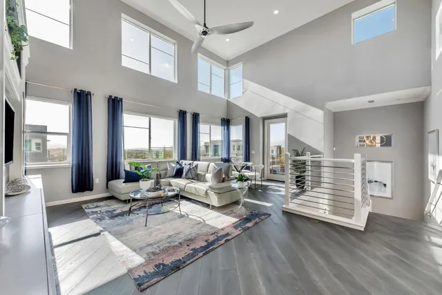 a workspace with furniture hardwood floor and a chandelier