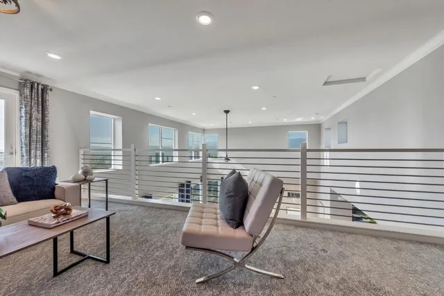 a bedroom with a large bed and a potted plant