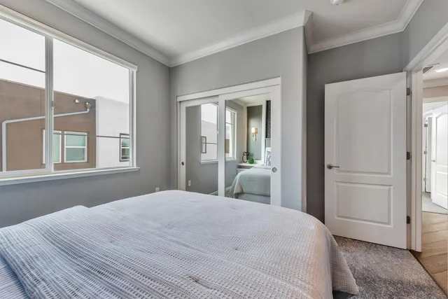 a bedroom with a bed and a painting on the wall