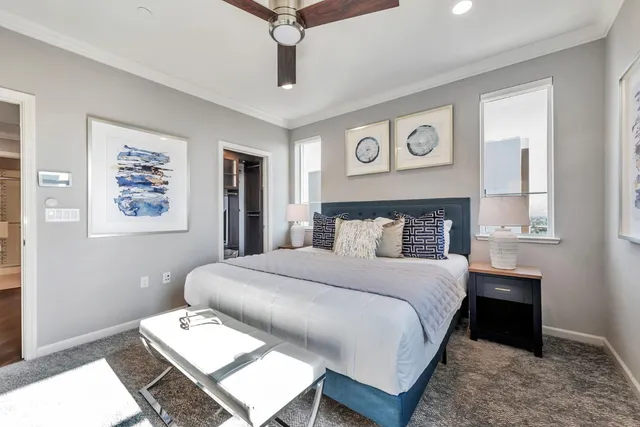 a bedroom with a large bed and a chandelier