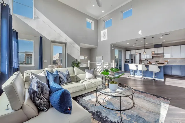 a living room with furniture kitchen view and a table