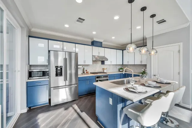 a kitchen with refrigerator cabinets and wooden floor
