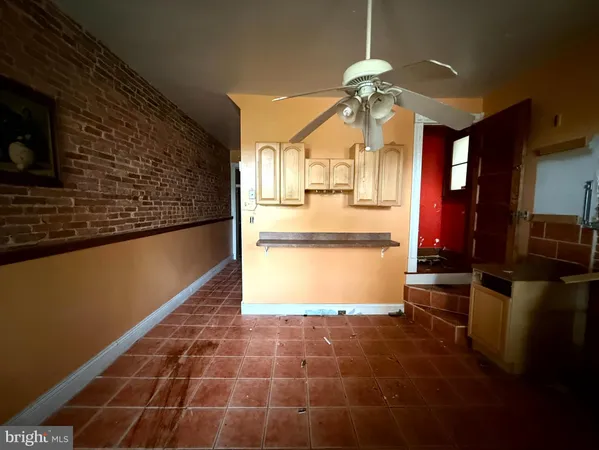 a kitchen with kitchen island a counter top space appliances and cabinets