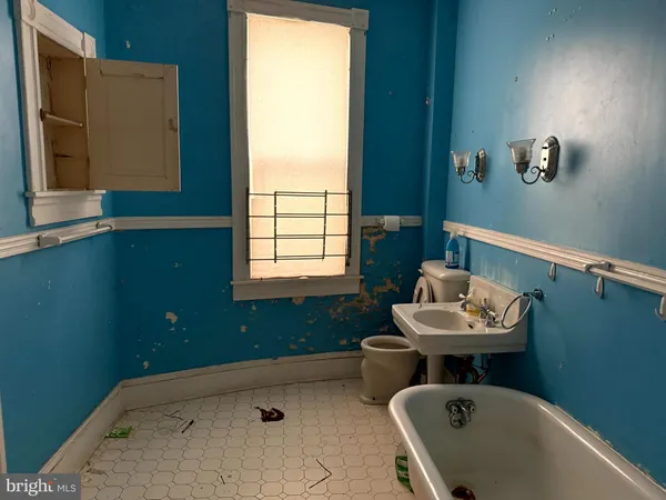 a bathroom with a sink toilet and a window