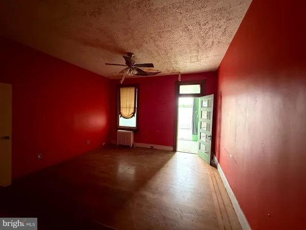 a view of a livingroom with wooden floor and a window