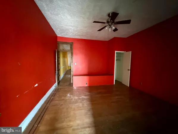 a view of a livingroom with a ceiling fan and window