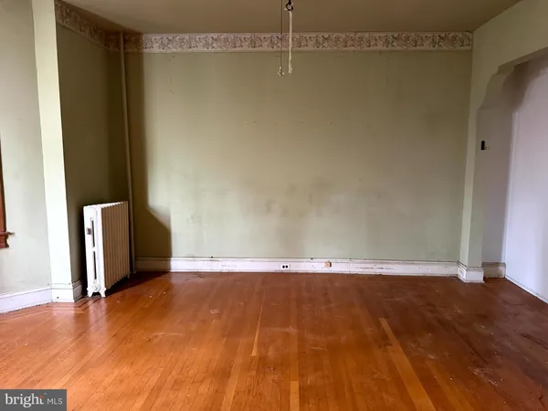 a view of a room with wooden floor
